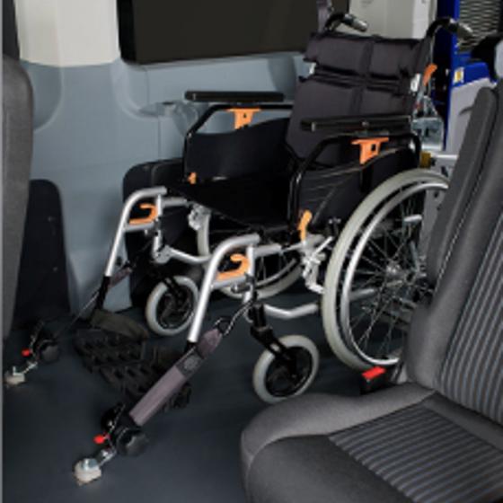 Moving and securing wheelchairs in a vehicle Image
